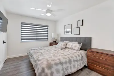 a bedroom with a bed and a ceiling fan at 1807 W Bay Unit B in Newport Beach