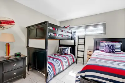 a bedroom with two bunk beds and a desk at 2010 W Oceanfront in Newport Beach