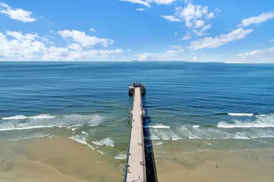 an aerial view of a pier over the ocean at 2010 W Oceanfront in Newport Beach