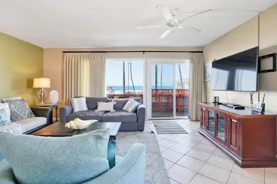 a living room with a couch and a tv at 2010 W Oceanfront in Newport Beach