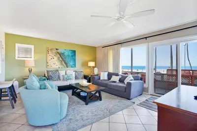 a living room with a couch and a table at 2010 W Oceanfront in Newport Beach