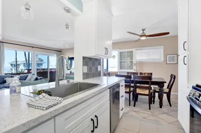 a kitchen with a sink and a dining room at 2010 W Oceanfront in Newport Beach