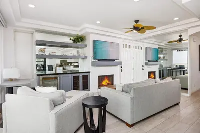 a living room with two couches and a fireplace at 204 E Oceanfront A in Newport Beach