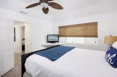 a bedroom with a white bed and a ceiling fan at 204 E Oceanfront A in Newport Beach