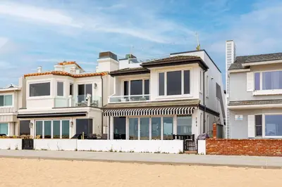 a large white house on the beach at 204 E Oceanfront B in Newport Beach
