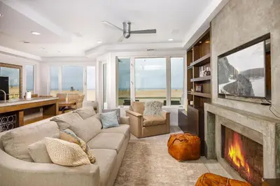 a living room with a couch and a fireplace at 204 E Oceanfront B in Newport Beach
