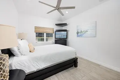a bedroom with a bed and a ceiling fan at 204 E Oceanfront B in Newport Beach
