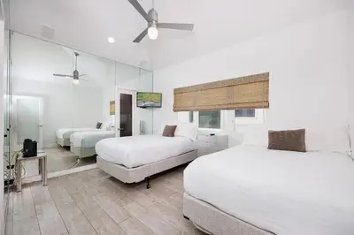 a hotel room with two beds and a couch at 204 E Oceanfront B in Newport Beach
