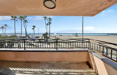 a balcony with a view of the beach at 2314 W Oceanfront A in Newport Beach