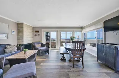 a living room with a table and a couch at 2314 W Oceanfront A in Newport Beach