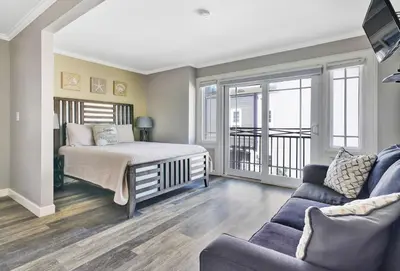 a bedroom with a bed and a couch at 2314 W Oceanfront A in Newport Beach