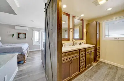 a bathroom with a sink and a bed in a room at 2314 W Oceanfront A in Newport Beach