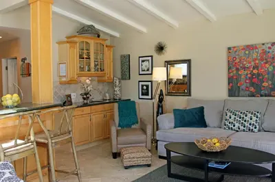 a living room with a couch and a table at Lower West Newport in Newport Beach