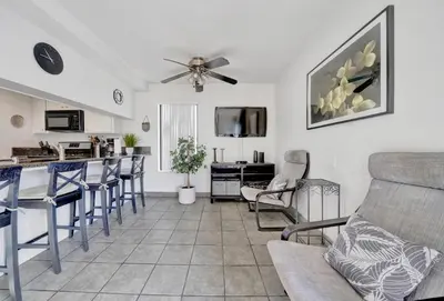 a kitchen and living room with a couch and chairs at 3 Bedrooms in Newport Beach