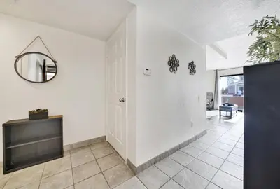 a hallway with a mirror on the wall and a mirror at 3 Bedrooms in Newport Beach