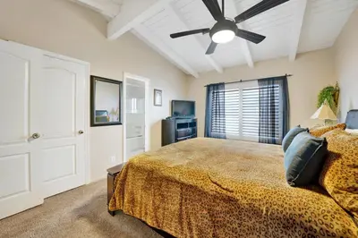 a bedroom with a bed and a ceiling fan at 4 Bedrooms in Newport Beach