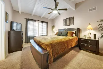a bedroom with a bed and a ceiling fan at 4 Bedrooms in Newport Beach