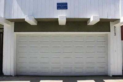 a garage door with a sign on top of it at 3112 W Oceanfront A in Newport Beach