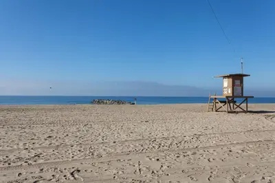 a beach with a life guard shack on the beach at 3112 W Oceanfront A in Newport Beach