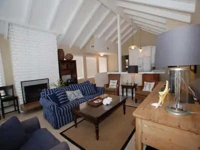 a living room with a blue couch and a table at 3112 W Oceanfront B in Newport Beach