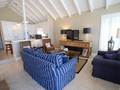 a living room with two blue couches and a television at 3112 W Oceanfront B in Newport Beach