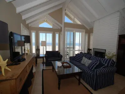 a living room with a couch and a tv at 3112 W Oceanfront B in Newport Beach