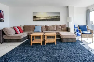 a living room with a couch and a table at Beatrice - Beachfront in Newport Beach