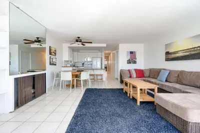 a living room with a couch and a table at Beatrice - Beachfront in Newport Beach