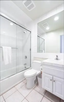a bathroom with a toilet and a shower and a sink at Beatrice - Beachfront in Newport Beach