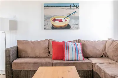 a living room with a couch and a bowl of fruit at Benjamin - Oceanview in Newport Beach