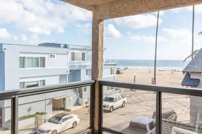 a balcony with a view of a beach and the ocean at Christopher - Oceanview in Newport Beach