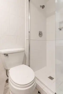 a white bathroom with a toilet and a shower at Daniel - Oceanview in Newport Beach