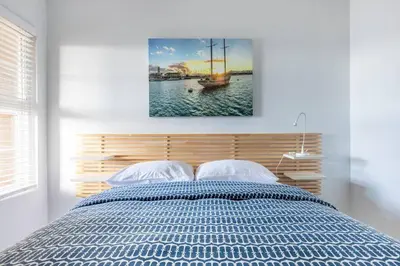 a bedroom with a bed with a painting on the wall at Daniel - Oceanview in Newport Beach