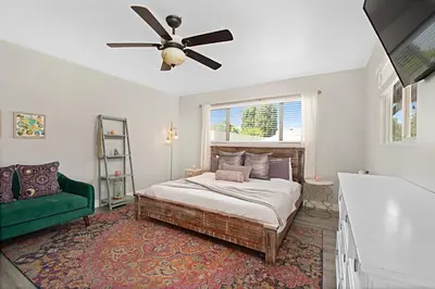 a bedroom with a bed and a ceiling fan at The Gathering Place - Guest Favorite with Huge Yard in San Diego