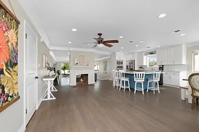 a kitchen and living room with a ceiling fan at The Gathering Place - Guest Favorite with Huge Yard in San Diego