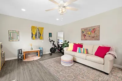 a living room with a couch and a ceiling fan at The Gathering Place - Guest Favorite with Huge Yard in San Diego