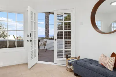 a living room with a door leading to a patio at The Pelican in Encinitas