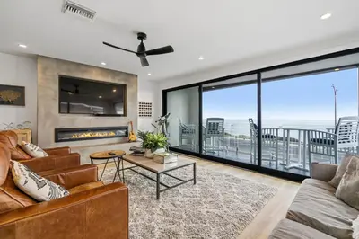 a living room with a couch and a fireplace at Private Beachside Home with HotTub in Carlsbad