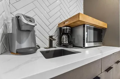 a kitchen counter with a coffee maker and a microwave at Private Beachside Home with HotTub in Carlsbad