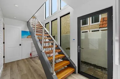a staircase in a house with a glass door at Private Beachside Home with HotTub in Carlsbad
