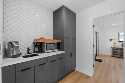 a kitchen with a sink and a microwave at Private Beachside Home with HotTub in Carlsbad
