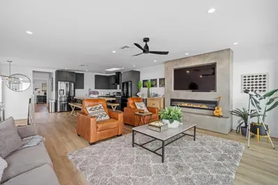 a living room with a couch and a fireplace at Private Beachside Home with HotTub in Carlsbad
