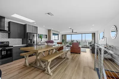 a kitchen with a wooden table and a dining room at Private Beachside Home with HotTub in Carlsbad
