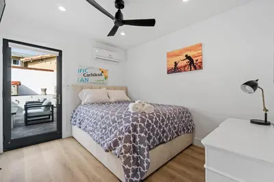 a bedroom with a bed and a ceiling fan at Private Beachside Home with HotTub in Carlsbad