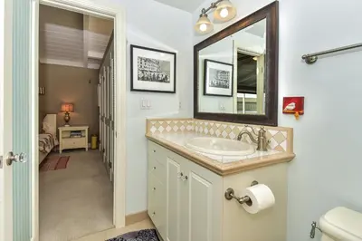 a bathroom with a sink and a mirror at 319 Coronado in Newport Beach