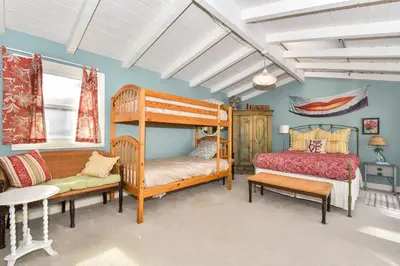 a bedroom with two bunk beds and a couch at 319 Coronado in Newport Beach
