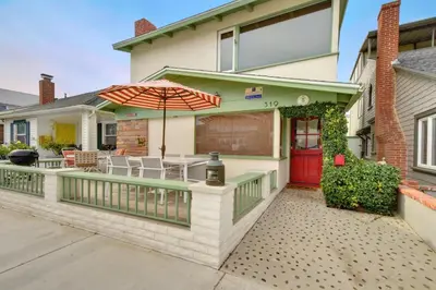 a house with a deck with an umbrella at 319 Coronado in Newport Beach
