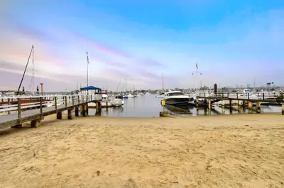 a dock with boats docked in the water at 319 Coronado in Newport Beach