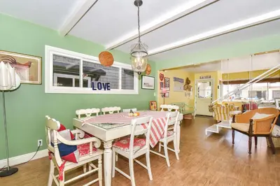 a dining room with a table and chairs at 319 Coronado in Newport Beach