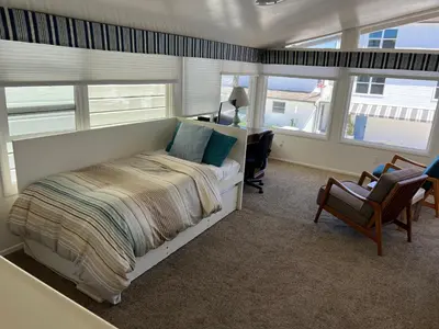 a bedroom with a bed and a desk and a chair at 327 Alvarado Pl in Newport Beach